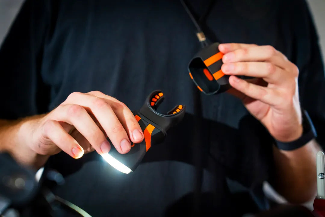 illumibite bite grip being removed from the flashlight for cleaning, showing proper care and maintenance to keep the bite grip hygiene and functioning effectively over time