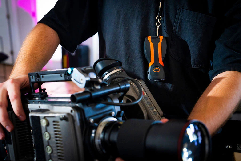 illumibite being worn around neck while doing camera and film maintenance hands-free