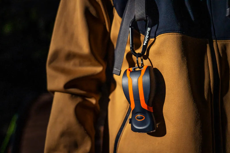 illumibite hands-free flashlight hanging from jacket using accessory loop and carabiner, showing easy carry and accessibility for everyday use