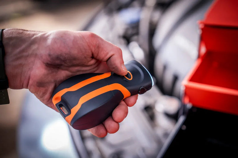 illumibite hands-free flashlight held in front of a toolbox, providing portable lighting for repair, maintenance, and job site tasks