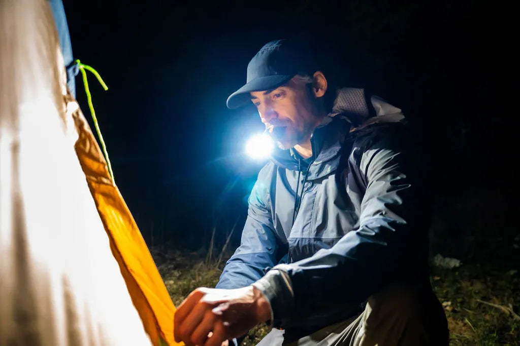 illumibite white LED lighting used in a camping setup at night, delivering bright hands-free lighting for outdoor tasks and tent preparation